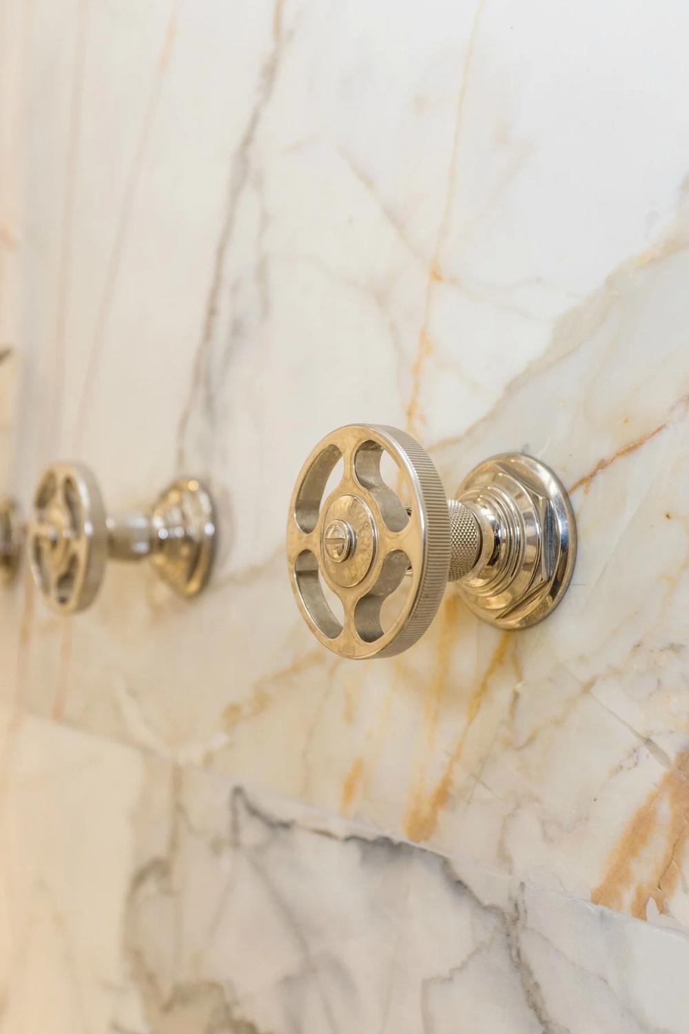 Brass door hardware set into a marble jamb