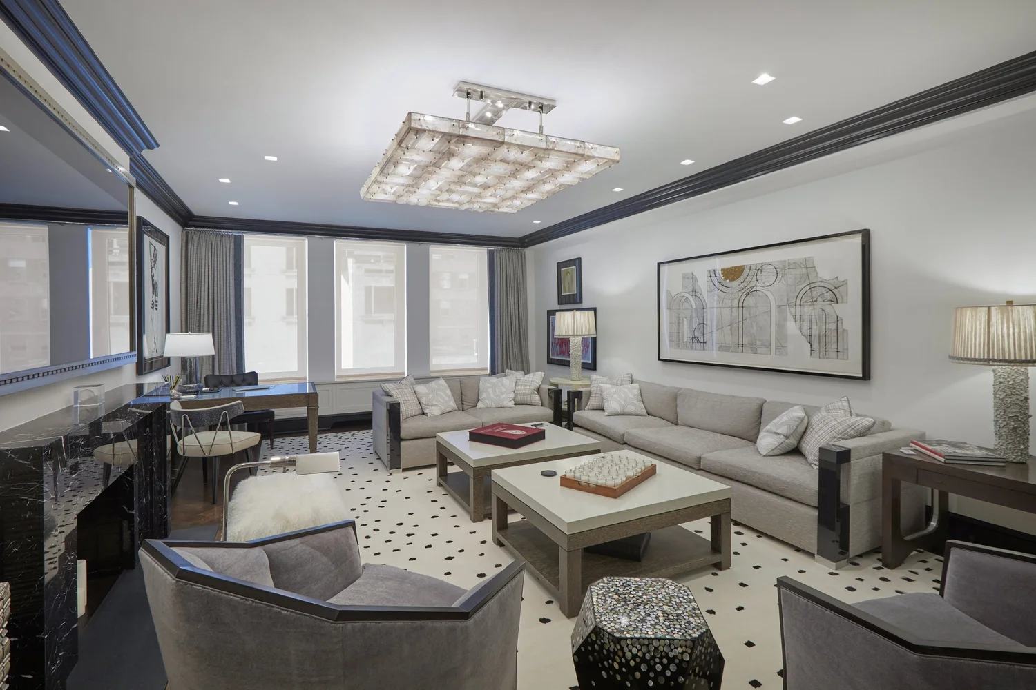 Living room of a renovated Park Avenue apartment with a polka-dot rug and a crystal ceiling fixture